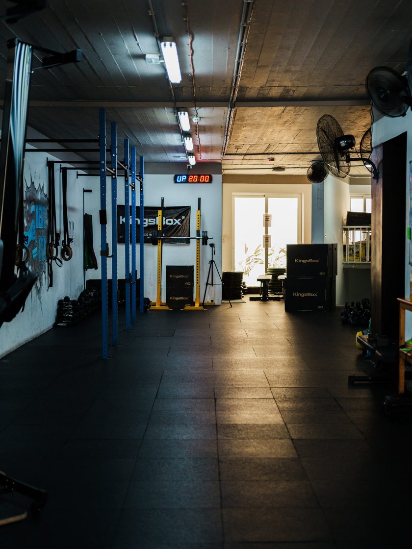 The top-floor gym from the far end, racks and kettlebells along the walls