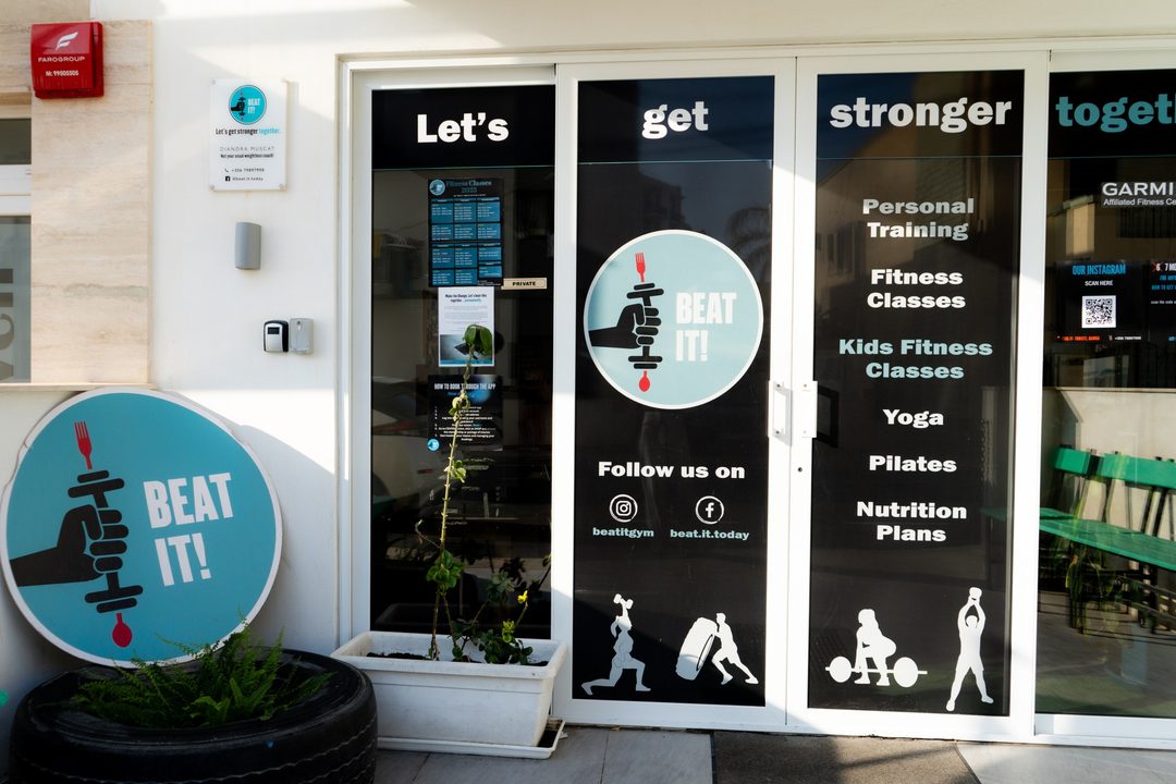 The Beat It entrance on Tourist Street in Qawra, with the round logo sign and the window lettering